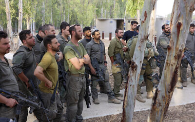 Israeli soldiers gather near the border with Gaza before entering the Hamas-run enclave on October 31, 2023. (Gil COHEN-MAGEN / AFP)