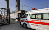 Palestinian health ministry ambulances cross the gate to enter the Rafah border crossing in the southern Gaza Strip before crossing into Egypt on November 1, 2023. (Mohammed ABED / AFP)