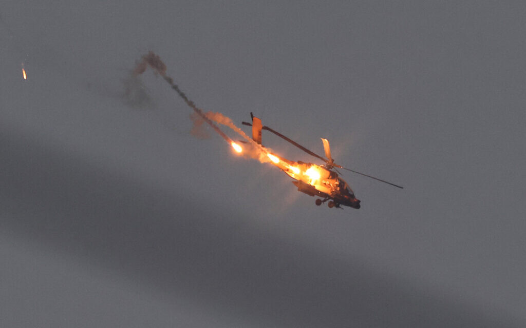 A picture taken from southern Israel shows an Israeli army helicopter launching flares over the Gaza Strip on November 1, 2023(Photo by JACK GUEZ / AFP)