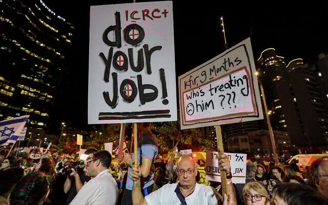 People gather with signs for a demonstration calling upon the International Committee of the Red Cross (ICRC) to take action for the release of hostages abducted by Palestinian terrorists on October 7 and currently held in the Gaza Strip, outside the ICRC offices in Tel Aviv on November 9, 2023. (AHMAD GHARABLI / AFP) People gather with signs for a demonstration calling upon the International Committee of the Red Cross (ICRC) to take action for the release of hostages abducted by Palestinian terrorists on October 7 and currently held in the Gaza Strip, outside the ICRC offices in Tel Aviv on November 9, 2023. (AHMAD GHARABLI / AFP)