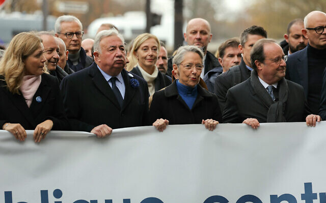 French Senate President Gerard Larcher (2ndL), President of the French National Assembly Yael Braun-Pivet (L), French Prime Minister Elisabeth Borne (C), France's former president Francois Hollande (2ndR) and former French prime minister and President of the Horizons party Edouard Philippe (R) stand behind a banner which reads as "For The Republic, Against antisemistism" before the start of the  march against antisemitism in Paris, on November 12, 2023. (Thomas SAMSON / AFP)