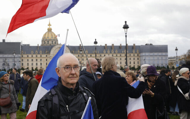 A protester stands next to flags of France during a march against antisemitism in Paris, on November 12, 2023. (Photo by Geoffroy Van der Hasselt / AFP) A protester stands next to flags of France during a march against antisemitism in Paris, on November 12, 2023. (Photo by Geoffroy Van der Hasselt / AFP)