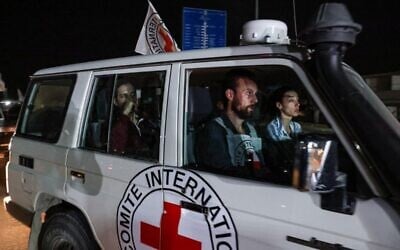 An International Red Cross vehicle carrying Russian-Israeli hostage Roni Krivoi released by Hamas drives towards the Rafah border crossing with Egypt, ahead of a transfer to Israel on November 26, 2023. (Mohammed ABED / AFP)