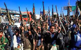 Armed Yemeni supporters of the Iran-backed Houthi rebels brandish their weapons at a rally in the capital Sanaa, January 27, 2022. (Mohammed Huwais/AFP)