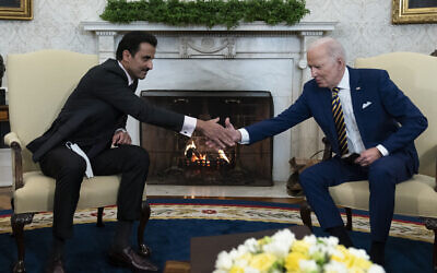 US President Joe Biden, right, shakes hands with Qatar's Emir Sheikh Tamim bin Hamad Al Thani in the Oval Office of the White House, January 31, 2022, in Washington. (AP Photo/Alex Brandon)