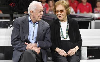 File: Former President Jimmy Carter, left, and his wife, former first lady Rosalynn Carter, right, sit together ahead of an NFL football game between the Atlanta Falcons and the Cincinnati Bengals, Sept. 30, 2018, in Atlanta (AP Photo/John Amis, File)