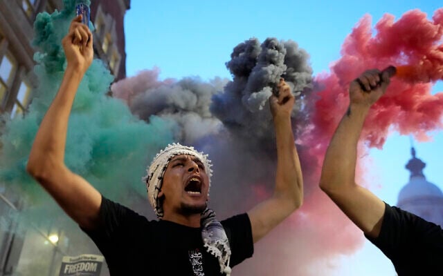 A protester holds flares during a pro-Palestinian, anti-Israel demonstration in London, Oct. 9, 2023, two days after Hamas terrorists carried out a massacre in Israel (AP Photo/Kirsty Wigglesworth)