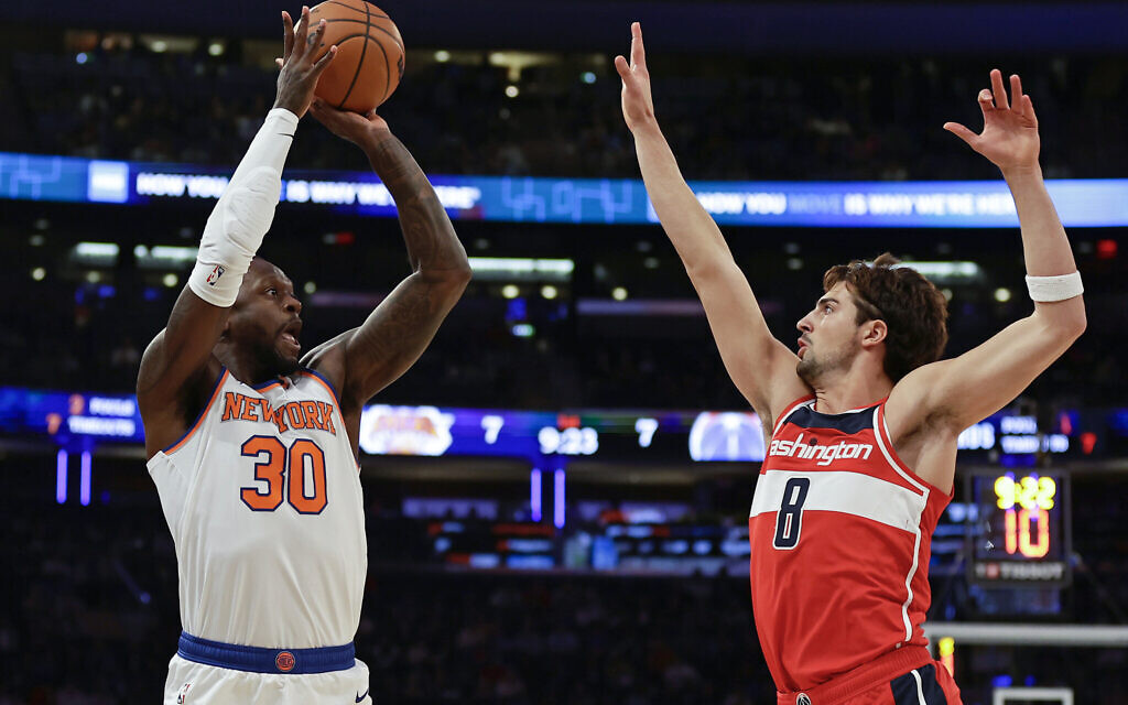 New York Knicks forward Julius Randle (30) shoots over Washington Wizards forward Deni Avdija (8) during the first half of a preseason NBA basketball game, October 18, 2023, in New York. (AP Photo/Adam Hunger)