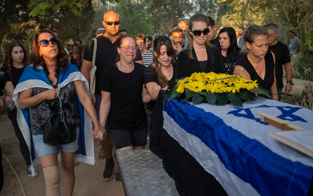 Relatives attend the funeral of Albert Miles, 81, at the Kibbutz Revivim cemetery, south Israel, Monday, Oct. 30, 2023. Albert Miles was killed by Hamas terrorists on Oct. 7, in Kibbutz Be'eri near the border with the Gaza Strip. (AP Photo/Bernat Armangue)