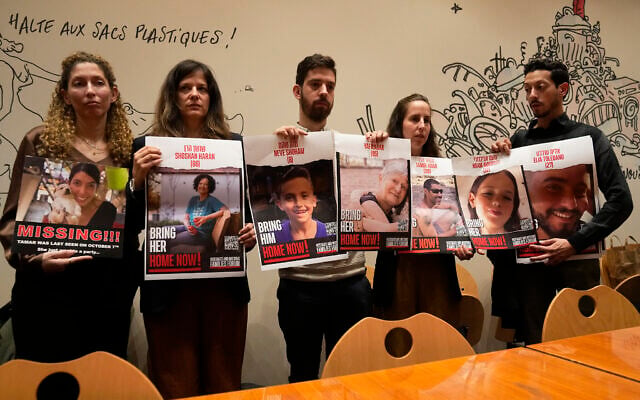 From left, Adva Gutman, Ayelet Sela bin Nun, Alon Adar, Adva Adar and Daniel Toledano, hold portraits of relatives held hostage by Hamas terrorists in Gaza, during a press conference at the Paris town hall, Tuesday, Oct. 31, 2023 in Paris. (AP/Michel Euler)