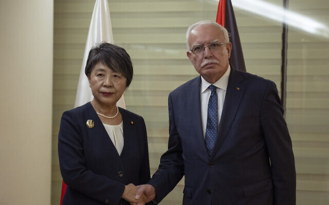 Palestinian Authority Foreign Minister Riyad al-Maliki, right receives his Japanese counterpart Yoko Kamikawa at his office in the West Bank city of Ramallah, Friday, Nov. 3, 2023. (AP Photo/Nasser Nasser)