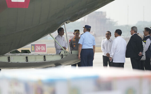 Indonesian President Joko Widodo, left, looks at relief supplies for Gaza, before its departure at Halim Perdanakusuma air base in Jakarta, Indonesia, Saturday, Nov. 4, 2023.  (AP Photo/Achmad Ibrahim)