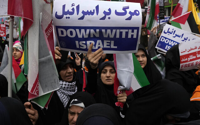 An Iranian demonstrator holds an anti-Israeli placard during a rally in front of the former US Embassy in Tehran, Iran, marking 44th anniversary of the seizure of the embassy by Iranian students, Saturday, Nov. 4, 2023. (AP Photo/Vahid Salemi) An Iranian demonstrator holds an anti-Israeli placard during a rally in front of the former US Embassy in Tehran, Iran, marking 44th anniversary of the seizure of the embassy by Iranian students, Saturday, Nov. 4, 2023. (AP Photo/Vahid Salemi)