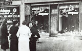 The November 1938 file photo shows a group of people standing outside a Jewish-owned shop in an unnamed German town, after Kristallnacht, when Nazi-incited mass riots left more than 91 Jews dead, damaged more than 1,000 synagogues and left some 7,500 Jewish businesses ransacked and looted. (AP Photo, File)