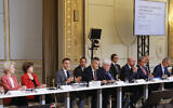 French President Emmanuel Macron, center, speaks during a meeting with officials from Western and Arab nations, the United Nations and nongovernmental organizations at the Elysee Palace, in Paris, November 9, 2023. (Ludovic Marin, Pool via AP)