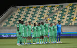 Players of Maccabi Haifa observe a minute of silence for the victims of Hamas attack, before the Europa League group F soccer match between Maccabi Haifa and Villarreal, at AEK arena stadium in Larnaca, Cyprus, on Nov. 9, 2023. (AP Photo/Petros Karadjias)