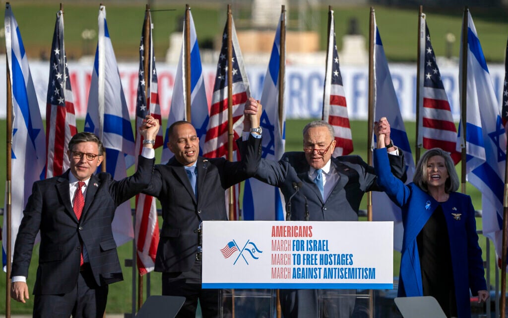 FILE - From left, Speaker of the House Mike Johnson., left, House Minority Leader Hakeem Jeffries, Senate Majority Leader Chuck Schumer, and Senator Joni Ernst, right, join hands at the March for Israel on November 14, 2023, on the National Mall in Washington. (AP Photo/Mark Schiefelbein)