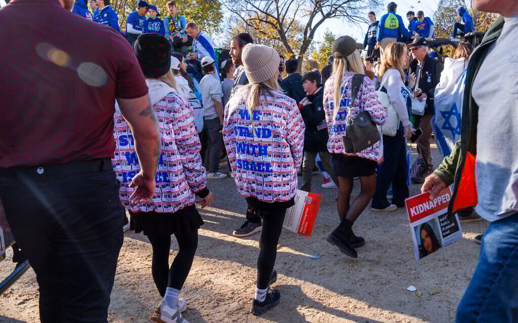 Women wearing jackets with the faces of people who were kidnapped by Hamas, attend the March for Israel rally, November 14, 2023, on the National Mall in Washington. (AP Photo/Jacquelyn Martin)