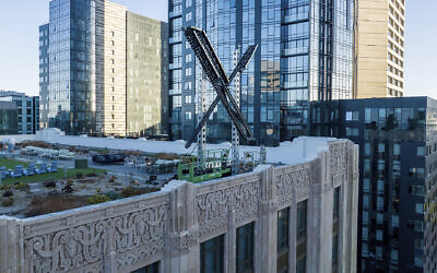 An 'X' sign rests atop the company headquarters in downtown San Francisco, on July 28, 2023. (Noah Berger/AP)
