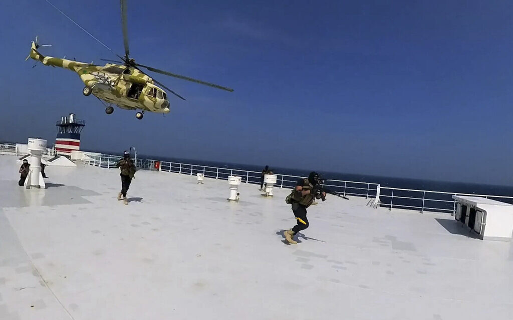 This photo released by the Houthi Media Center shows Houthi forces boarding the cargo ship Galaxy Leader on Sunday, November 19, 2023. (Houthi Media Center via AP)
