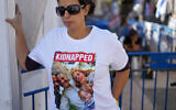 Ofri Bibas wears a shirt with a picture of her brother, sister-in-law and their two children, age 4 and 10 months, held hostage in Gaza, in Tel Aviv, Nov. 21, 2023. (AP/Ariel Schalit)