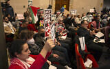 Audience members show their support at a special session of the Oakland City Council for a resolution calling for an immediate ceasefire in Gaza, Monday, Nov. 27, 2023, in Oakland, Calif. (AP Photo/D. Ross Cameron)