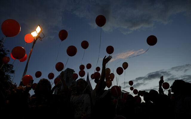 Protesters release balloons as they call for the release of the Bibas family, whose members are being held hostage in the Gaza Strip by the Hamas terror group, in Tel Aviv, Nov. 28, 2023 (AP Photo/Ariel Schalit) Protesters release balloons as they call for the release of the Bibas family, whose members are being held hostage in the Gaza Strip by the Hamas terror group, in Tel Aviv, Nov. 28, 2023 (AP Photo/Ariel Schalit)
