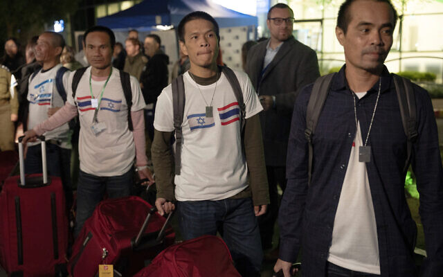 Thai nationals walk to a bus as they leave the Shamir Hospital in Ramle, Israel, Wednesday, Nov. 29, 2023, on their way back to Thailand, after being released from Hamas captivity. (AP/Maya Levin)