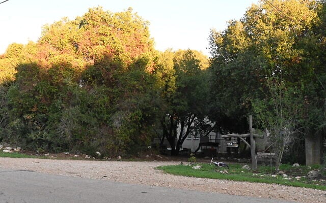 A child's bicycle lies in the front yard of a house in Abirim Israel, pictured here on November 21, 2023, whose residents have left because of Hezbollah rockets. (Canaan Lidor/Times of Israel)