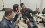 Thai national Nutthawaree Munkan, center, speaks via video call with Israeli Danielle Aloni, a virtual reunion for the two women after they were released from being hostages of the Hamas terror group, November 29, 2023. (Israel Foreign Ministry)