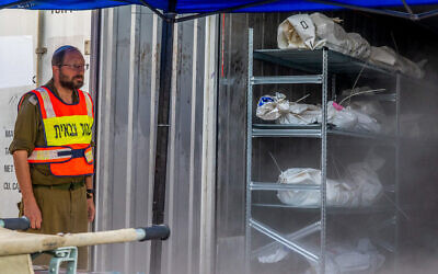 A soldier mans the makeshift mass casualty morgue at the Shura military base near Ramle, October 24, 2023. (Yossi Aloni/Flash90)