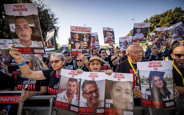 Hundreds of Israelis hold photographs of abducted and missing family members outside the Knesset, November 6, 2023. (Yonatan Sindel/Flash90) Hundreds of Israelis hold photographs of abducted and missing family members outside the Knesset, November 6, 2023. (Yonatan Sindel/Flash90)