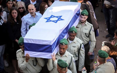 David Lubin, in the light blue shirt, attends the funeral of his daughter Rose Elisheva Lubin at the Mount Herzl Military Cemetery in Jerusalem on November 9, 2023. (Yonatan Sindel/Flash90)