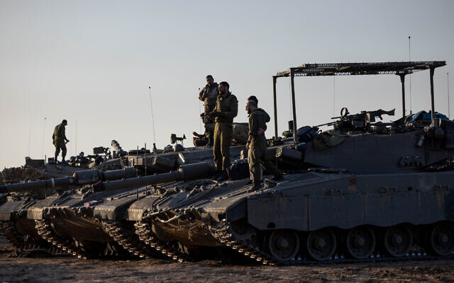 Israeli soldiers seen at a staging area near the Israeli-Gaza border, southern Israel, November 29, 2023. (Chaim Goldberg/Flash90) Israeli soldiers seen at a staging area near the Israeli-Gaza border, southern Israel, November 29, 2023. (Chaim Goldberg/Flash90)