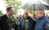 US billionaire Elon Musk, left, and Prime Minister Benjamin Netanyahu, center, take a tour of Kfar Aza, November 27, 2023. (Amos Ben Gershom/GPO)
