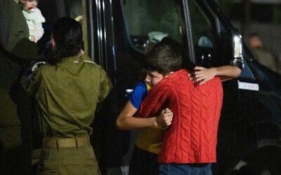 Eitan Yahalomi hugs his mother after getting off an IDF helicopter after being released from Hamas captivity on November 27, 2023 (Israel Defense Forces)