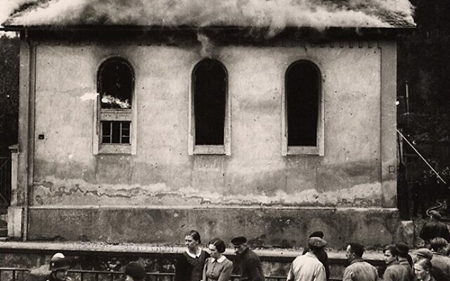 On the morning after Kristallnacht, or the "Night of Broken Glass," local residents watch as the synagogue in Ober-Ramstadt, Germany, is destroyed by fire in 1938. (CNS photo/United States Holocaust Memorial Museum)