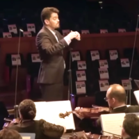 Israel Philharmonic maestro Lahav Shani performing a live broadcast concert on October 22, 2023, playing to the faces of the Hamas hostages. (Courtesy)