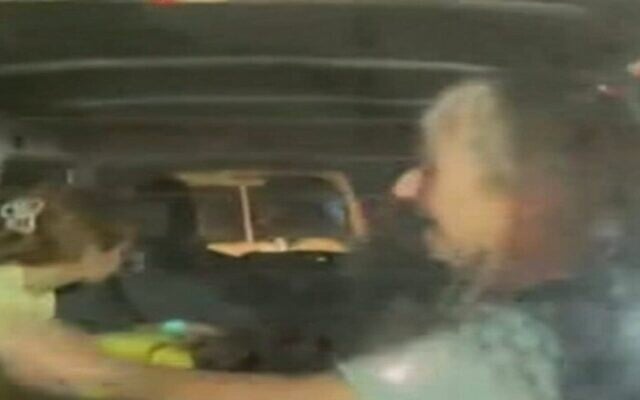 A woman is seen waving in first footage of the Israeli hostages in ambulances making their way through Egypt's Rafah Crossing on November 24, 2023. (Screen capture/X)