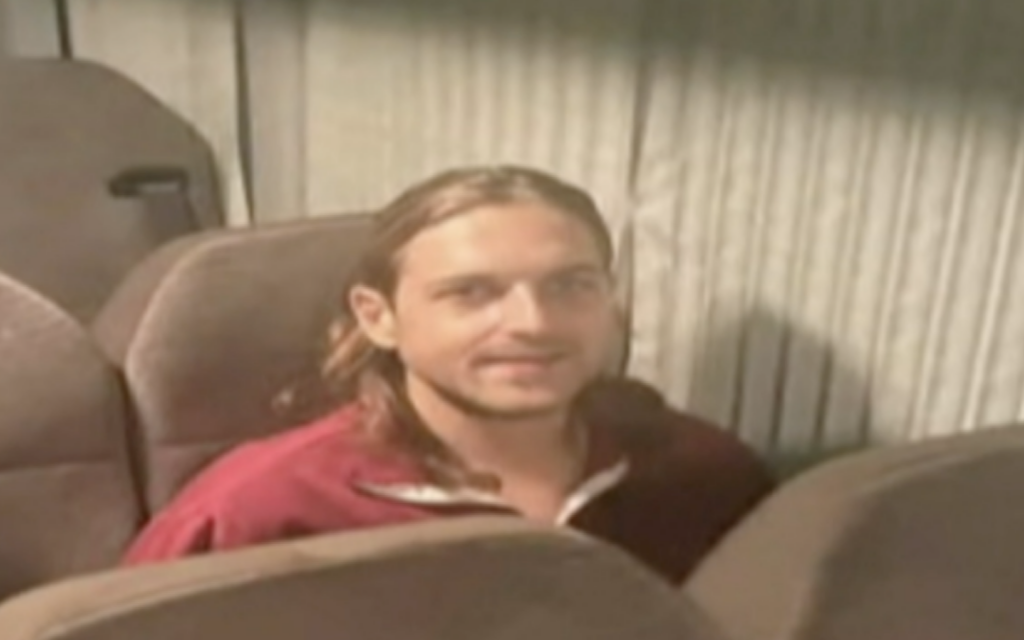 Russian-Israeli Roni Krivoi is seen inside the International Red Cross vehicle at the Rafah border crossing with Egypt ahead of his transfer to Israel on November 26, 2023. (Screenshot)