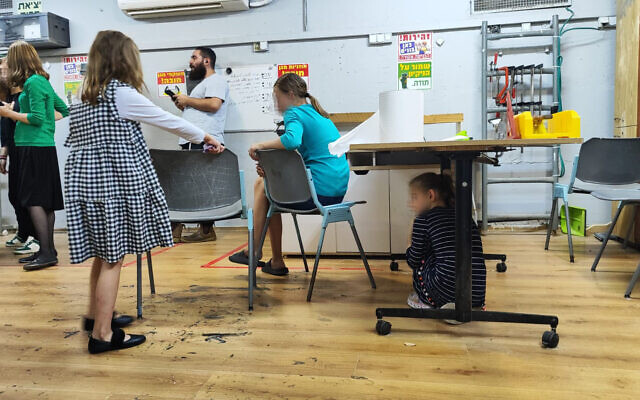 Alumim foster children wait in a bomb shelter for the all-clear, in Kfar Chabad, central Israel., October 26, 2023. (Gavriel Fiske/Times of Israel)
