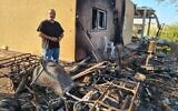 Gili Okev sits outside his ruined house in Kfar Aza, a month after Hamas terrorists invaded and killed many of his neighbors. (Deborah Danan via JTA)
