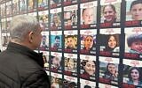 Prime Minister Benjamin Netanyahu looks at posters of the Gaza hostages on November 14, 2023. (Amos Ben Gershom/GPO)