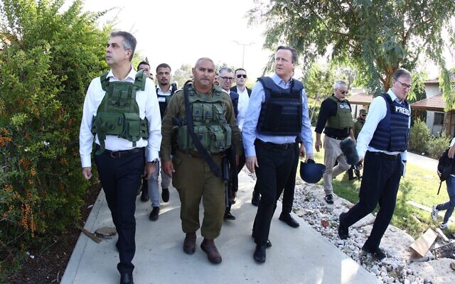 Foreign Minister Eli Cohen (left) escorts UK Foreign Secretary David Cameron (right) through Kibbutz Be'eri on November 23, 2023. (Miri Shimonovich/Foreign Ministry) Foreign Minister Eli Cohen (left) escorts UK Foreign Secretary David Cameron (right) through Kibbutz Be'eri on November 23, 2023. (Miri Shimonovich/Foreign Ministry)