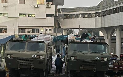Medical teams at Shifa Hospital unload Israeli aid from trucks in northern Gaza, in this IDF handout photo released on November 18, 2023. (IDF)