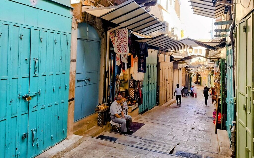 A souvenir shop owner sits on a nearly empty street in Jerusalem's Old City, following a halt in the tourist influx due to the Israel-Hamas war, November 6, 2023 (Gianluca Pacchiani/Times of Israel) A souvenir shop owner sits on a nearly empty street in Jerusalem's Old City, following a halt in the tourist influx due to the Israel-Hamas war, November 6, 2023 (Gianluca Pacchiani/Times of Israel)