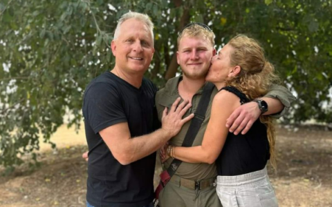 The late Shachar Friedman, center, who was killed in Gaza on November 19, 2023, and his parents, before he entered Gaza. (Facebook screen capture, used in accordance with Clause 27a of the Copyright Law)