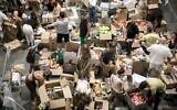 Illustrative: Volunteers pack donations of food and other necessities for Israeli soldiers and citizens in the south, in Tel Aviv, October 9, 2023. (Miriam Alster/Flash9)