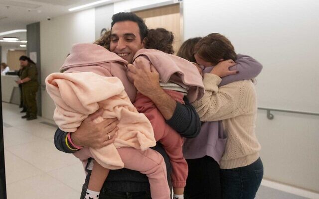 Yoni Asher embraces his daughters Raz and Aviv after their release from Hamas captivity on November 24, 2023. (Israel Defense Forces) Yoni Asher embraces his daughters Raz and Aviv after their release from Hamas captivity on November 24, 2023. (Israel Defense Forces)