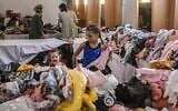 Illustrative: Israeli evacuees from the Gaza border area get temporary shelter at a hotel in Eilat, October 17, 2023. (Aris MESSINIS / AFP)